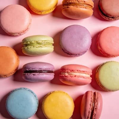 Colorful macarons on pink background